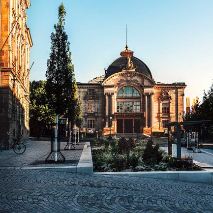 Die Sandsteinfassade des Fürther Stadttheaters leuchtet in der warmen Morgensonne und strahlt Ruhe aus