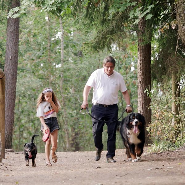 Alex vom Hotel Forsthaus mit seiner Tochter und Hunden beim Spaziergang am Wildschweingehege im Fürther Stadtwald.