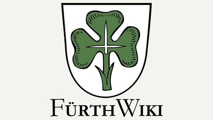 Logo von Fürth Wiki zeigt ein grünes Kleeblatt in einem Wappen als Stadt- und Symbolzeichen.