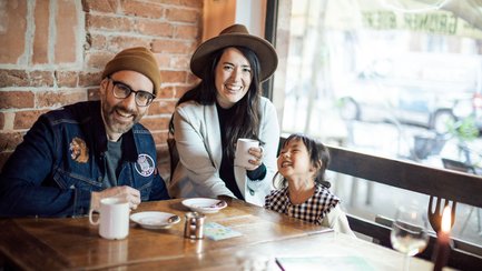 Eine Familie trinkt gemeinsam Kaffee mit ihrer Tochter in einem Café in Fürth