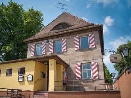 Sandsteingebäude des Alten Forsthauses in Fürth mit kleinem Anbau und einladender Außenansicht