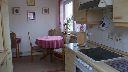 Kleiner Essbereich im Apartment Angelika in Fürth mit Pflanzen und Bildern neben der Küche